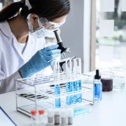 Researchers looking through a microscope