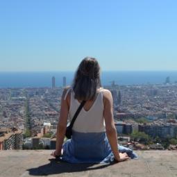 Girl looking at panoramic views of Barcelona from the Bunkers del Carmel