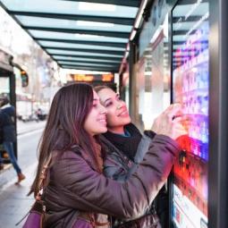 Two girls looking at a Barcelona public transport map