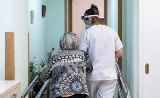 Carer accompanying an elderly person