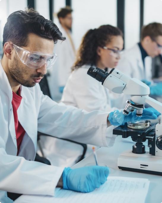 Researchers looking through a microscope