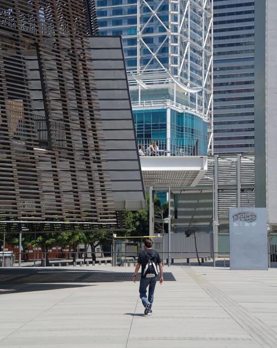 Person walking among Barcelona’s modern buildings